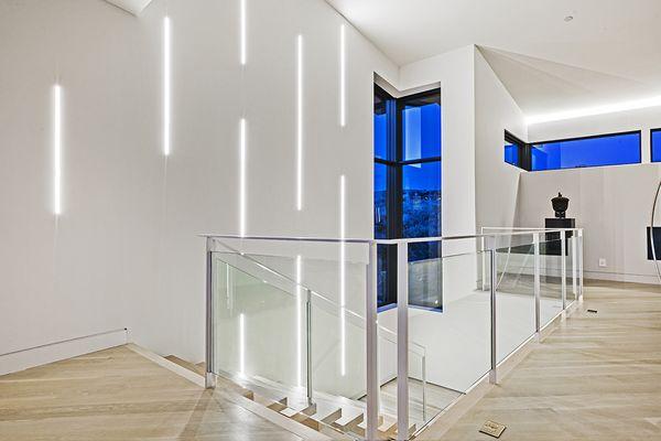 Beautiful matte white, metal and glass handrail. located in Park City.