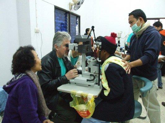 Dr. Haines doing pre-op exam for patient in Asia during cataract removal mission.