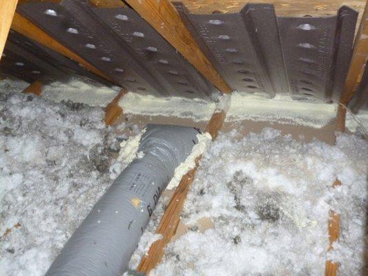 Attic being air sealed in preparation for insulation