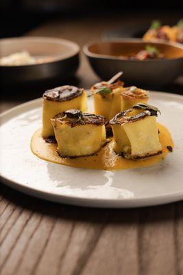 Pumpkin pasta with goat cheese and basil.