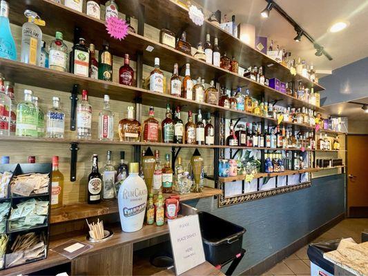 Display of booze they serve at this hybrid coffee shop!