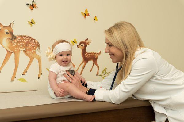 Dr. Jill examining a beautiful baby.