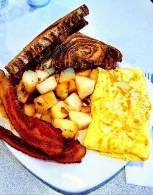 Three egg cheese omelet with hickory smoked bacon, American fries with onions and rye toast! Yummy!