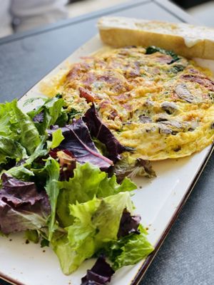 Frittata-Rustica Omelet with a side of salad.