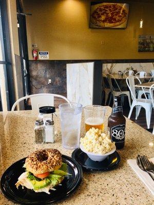 Roasted Turkey bagel sandwich (added avocado), side of macaroni salad, and a beer for lunch. $21 and some change.