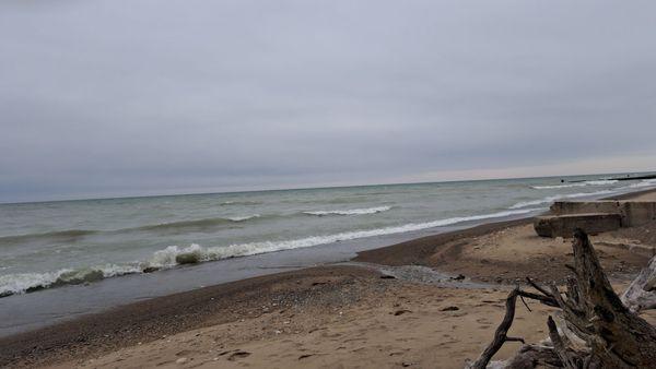 Lakefront view of crashing waves on a blustery and overcast March day