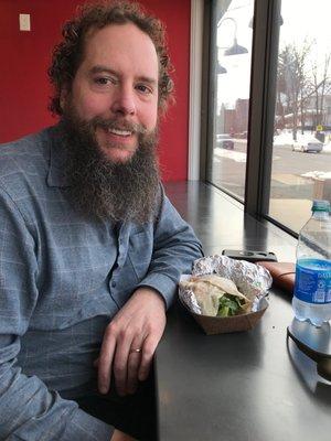 Fuzzy eating a burrito while people watching.