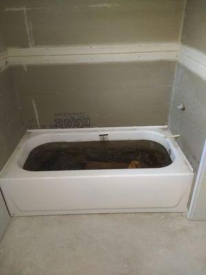 Bathtub with black stinking water left for months.