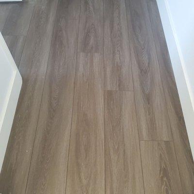 Floor transition from restroom to hallway and bedroom