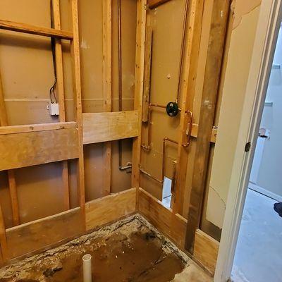 Drain is moved to the center and a new shower valve is installed. This on is going to look great.