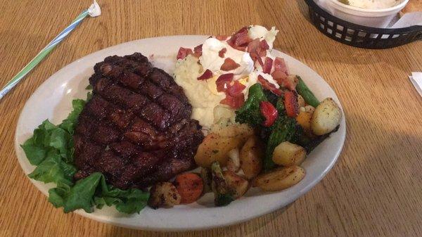 10oz Ribeye, loaded garlic mashed potatoes, roasted veggies.