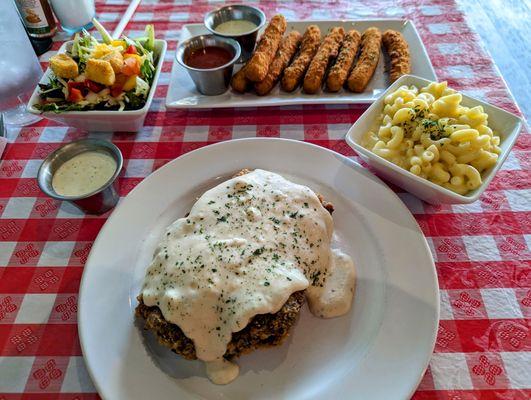 chicken fried steak with side salad, mac & cheese, and cheese sticks