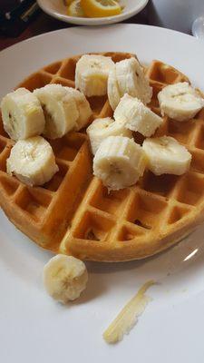 Belgium waffle with banana fruit topping.