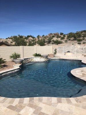 Freeform Pool with travertine flooring.