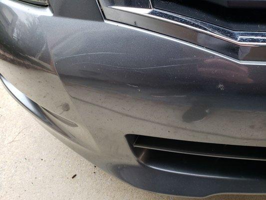 Swipe scratches across the bumper, which the manager tried to claim was somehow from driving on the road.