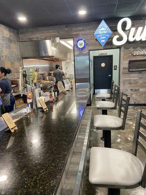 Bar stool area perfect for enjoying a cold brew on tap. sandwich and a soda