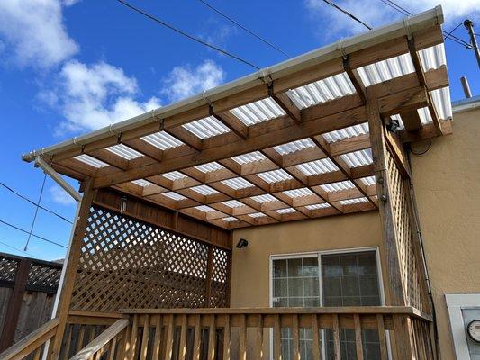 New backyard porch covering/roof installed including additional pieces added to wood frame