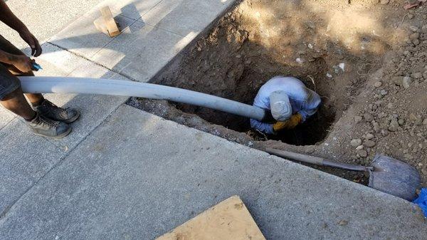 Guiding the new pipe in.