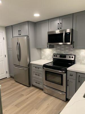 After picture of the kitchen. The client went with a quartz countertop with gray cabinets.