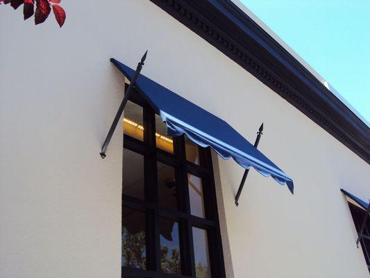 Flat-panel awning with decorative spears.