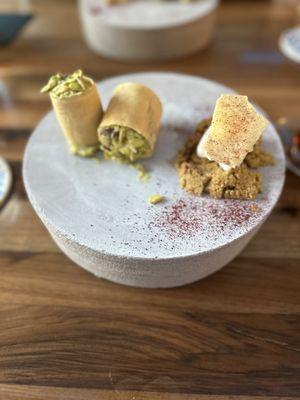 Pistachio pakhlava/baklava served on a solid round wooden "pedestal"