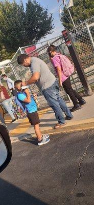 The school giving out masks and breakfast before entering school because of pandemic