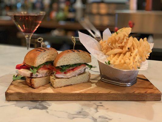 GRILLED CHICKEN SANDWICH brie cheese, strawberries, tomatoes, arugula, and a balsamic reduction served on a toasted brioche with waffle frie