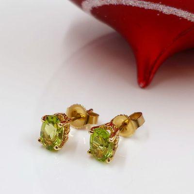 Peridot earrings in 14k yellow gold .