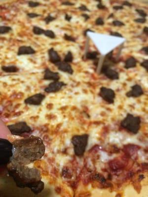 Beef pizza is burnt sausage bits that are overly salted