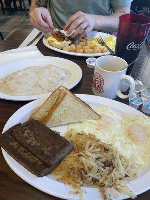 Scrapple, eggs over easy, hash brown, toast, chipped beef gravy on 1 biscuit, tater tots, scrambled eggs, and biscuits!