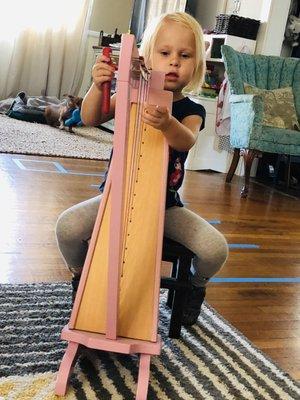 3 year old playing the harp