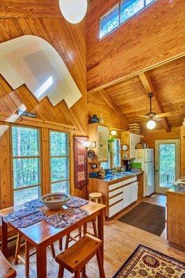 Dining & Kitchen with view of woods & back deck.