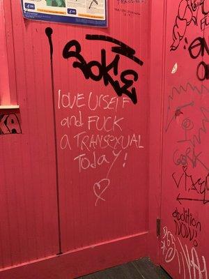 beautiful graffiti in the bathroom that reads "love urself and fuck a trans exual today!"