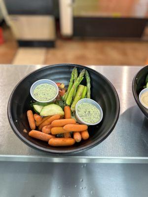 Kale and Quinoa vegetarian bowl - with asparagus, cucumbers, carrots, and corn and black bean.  Goddess sauce on the side.