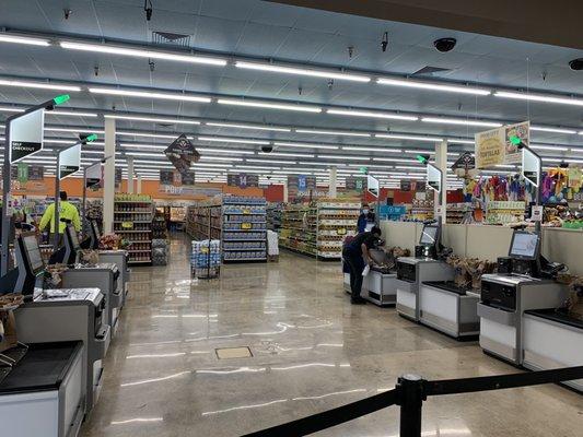 Employee sanitizing the self checkout stations