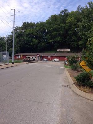 Located between a creek and a hill at an intersection next to Sam Davis Park.