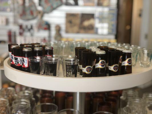 Shot glasses, including some made from the top of old beer bottles.