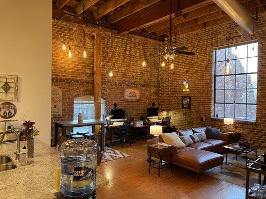 A real industrial loft with exposed brick and rustic beams and columns.