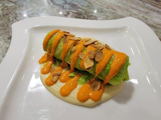 Savoy cabbage stuffed with saffron rice, celery root pureed and romesco sauce.