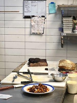 Kitchen, with smoked brisket waiting to be sliced.