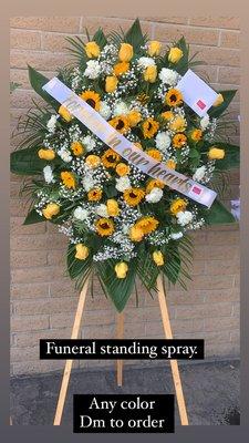 Funeral standing spray, premium size. Sunflowers, yellow roses, white carnations, baby's breath and greenery. Includes ribbon and stand.