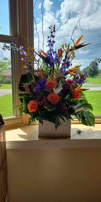 Requested tropical arrangement and they captured the vision beautifully. Birds of paradise, ferns all picking up the warm Aloha feeling.