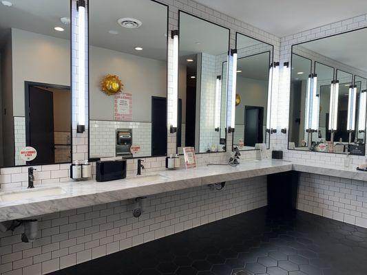 Women's locker room - plenty of sinks, OUAI products, Dyson hair dryers