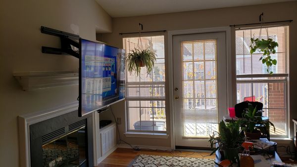 55" TV over fireplace with MantelMount, pulled down for easy eye level watching.