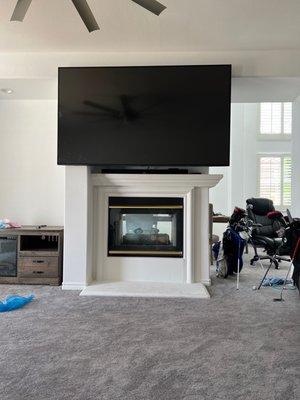 85 inch tv mounted over the fireplace