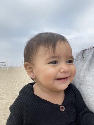 At the beach with her new earrings.