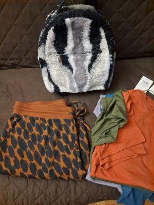 For $75 and change - Two long sleeve shirts, two short sleeve shirts, leopard joggers, and furry mini backpack.