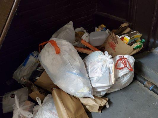 Trash under stairs_no bins in basement