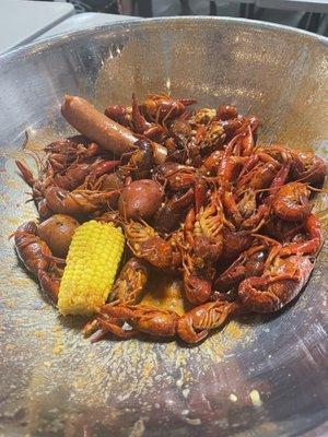 Crawfish, sausage, potatoes, and corn.