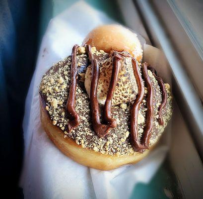 Smores donut with chocolate frosting, graham cracker crumbles and the best part... AN ACTUAL TOASTED MARSHMELLOW IN THE MIDDLE!